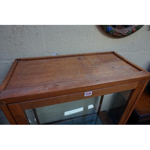 1141 - An oak table top display cabinet, 72cm high x 64.5cm wide x 32.5cm deep. 