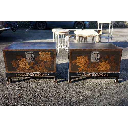 1155 - A small pair of Chinese black lacquered and gilt chests on stands, 61cm wide.