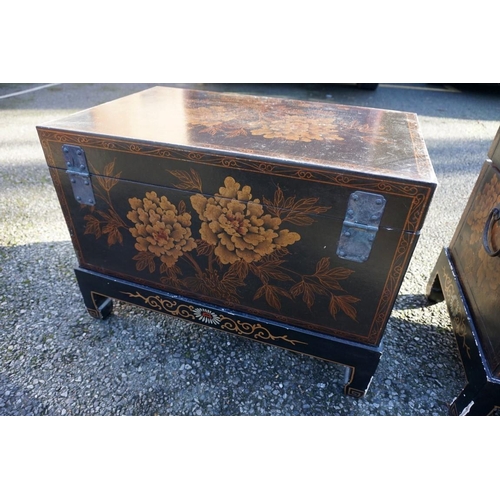 1155 - A small pair of Chinese black lacquered and gilt chests on stands, 61cm wide.