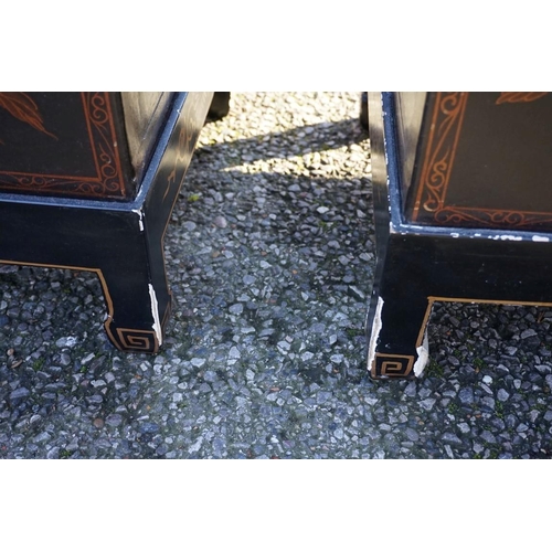 1155 - A small pair of Chinese black lacquered and gilt chests on stands, 61cm wide.