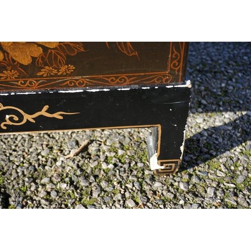 1155 - A small pair of Chinese black lacquered and gilt chests on stands, 61cm wide.