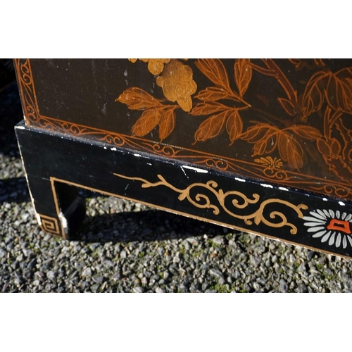 1155 - A small pair of Chinese black lacquered and gilt chests on stands, 61cm wide.