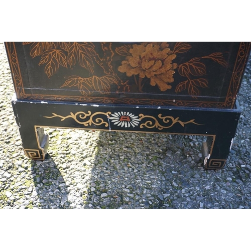 1155 - A small pair of Chinese black lacquered and gilt chests on stands, 61cm wide.