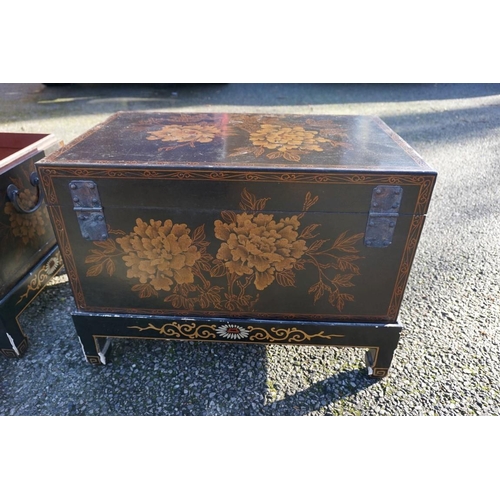 1155 - A small pair of Chinese black lacquered and gilt chests on stands, 61cm wide.