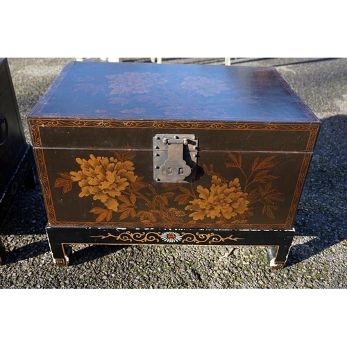 1155 - A small pair of Chinese black lacquered and gilt chests on stands, 61cm wide.