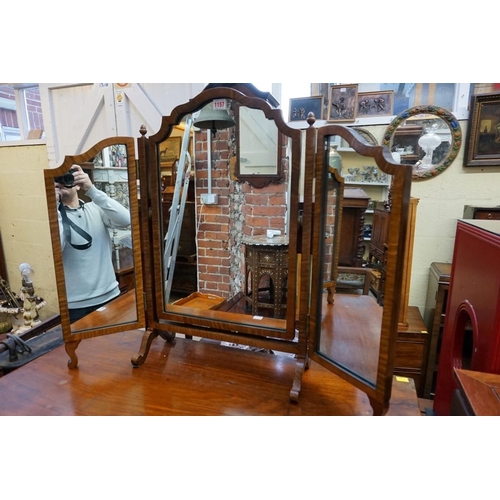 1157 - A 1930s walnut triptych mirror, 68.5cm wide; together with another similar easel back example, 58.5c... 