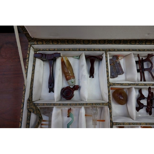 1158 - A cased set of Chinese hardstone musical instruments, 20th century, approx 26, most with wood s... 