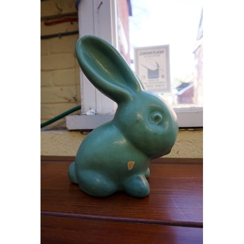 1174 - A graduated set of three Denby rabbits, largest 27cm high, (glaze flake to largest).... 