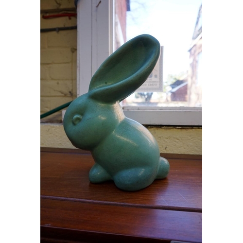 1174 - A graduated set of three Denby rabbits, largest 27cm high, (glaze flake to largest).... 