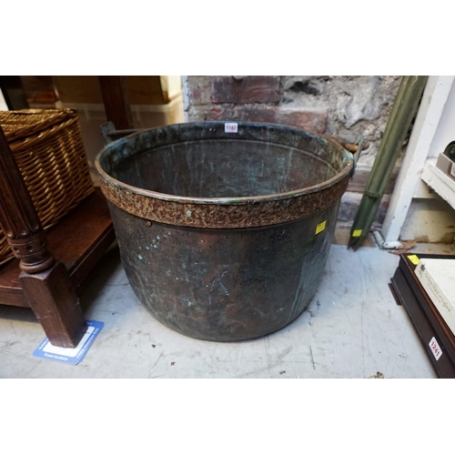 1182 - A large Victorian copper swing handled cauldron, with steel band to rim, 48cm diameter. ... 