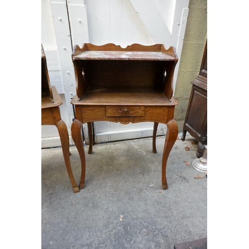 1184 - A pair of Continental oak and marble top bedside tables, 53.5cm wide.