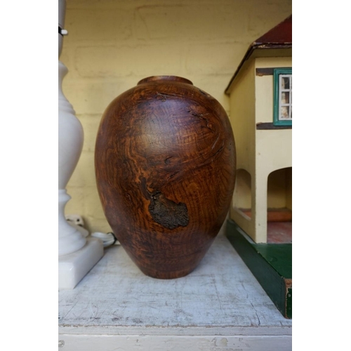 1215 - A turned burr oak vase, 27cm high. 