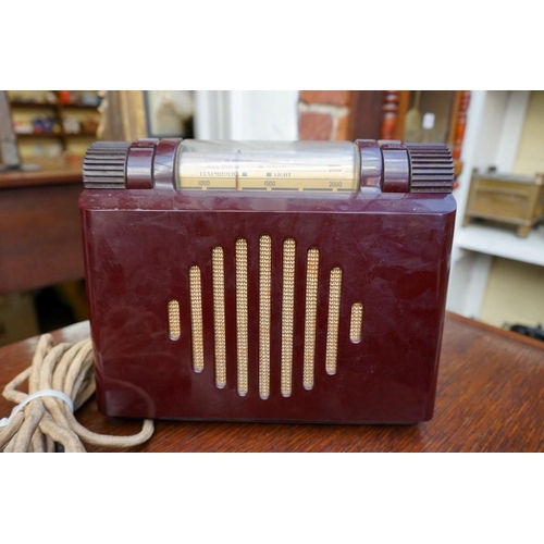 1228 - A vintage Murphy A100 maroon Bakelite radio, 23cm wide.