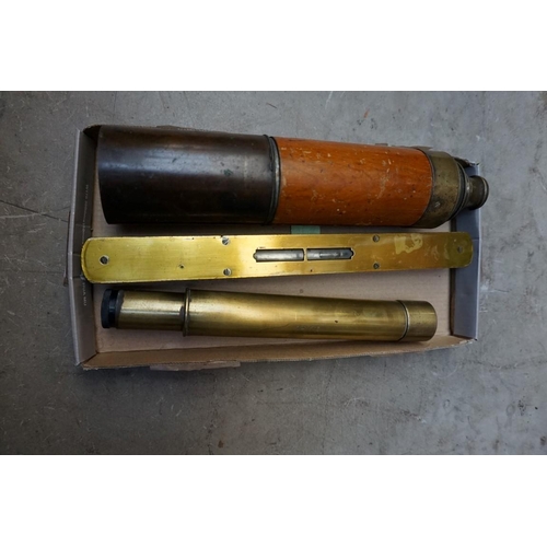 1233 - An old brass two drawer telescope, 64.5cm extended; together with a mahogany and brass spirit level;... 