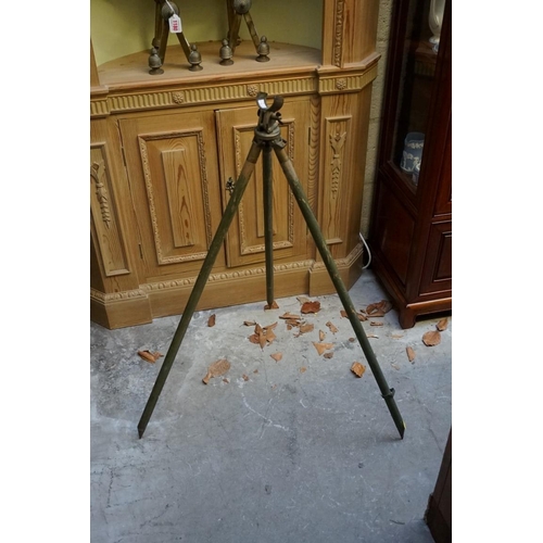 1233 - An old brass two drawer telescope, 64.5cm extended; together with a mahogany and brass spirit level;... 