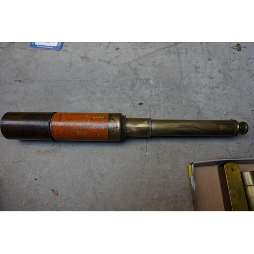 1233 - An old brass two drawer telescope, 64.5cm extended; together with a mahogany and brass spirit level;... 