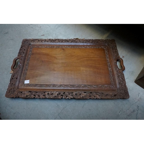 1244 - An Eastern carved walnut twin handled tray, 61cm wide; together with an 19th century rosewood s... 