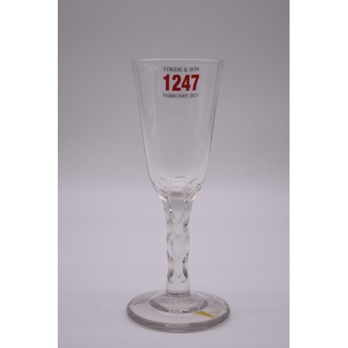 1247 - An 18th century English ale glass, with facet cut stem, 18cm high.