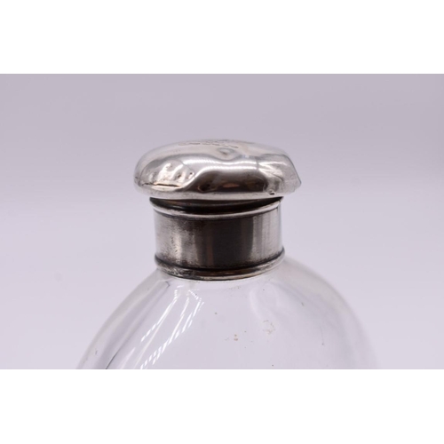 1248 - An unusually large 19th century clear glass flask, engraved with a crest, with electroplated li... 