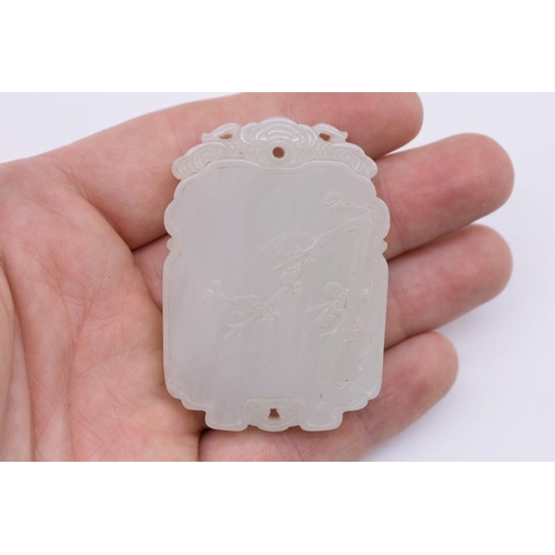 1251 - A Chinese carved pale celadon jade pendant, probably Qing, decorated in shallow relief with flowerin... 