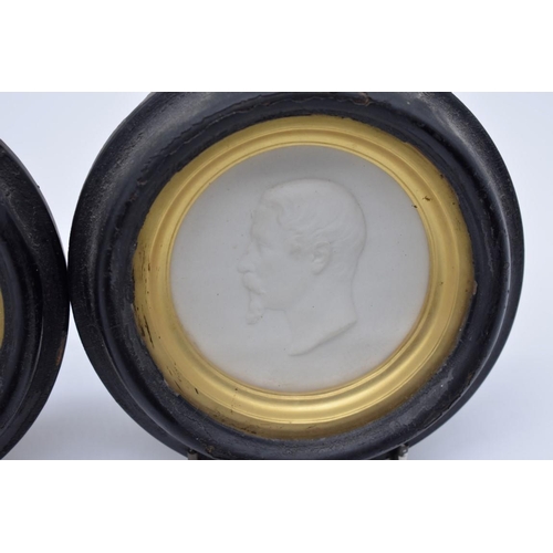 1254 - A pair of 19th century Sevres bisque circular relief plaques of Napoleon III and Eugénie, each insc... 