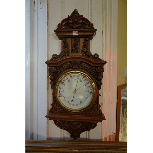 1268 - A Victorian carved walnut aneroid wall barometer, 83.5cm high. 