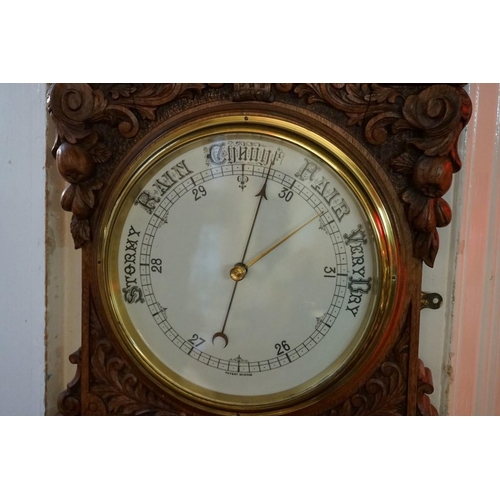 1268 - A Victorian carved walnut aneroid wall barometer, 83.5cm high. 