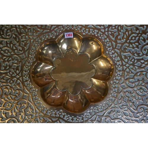 1303 - An Eastern brass top folding occasional table, 79cm diameter. 