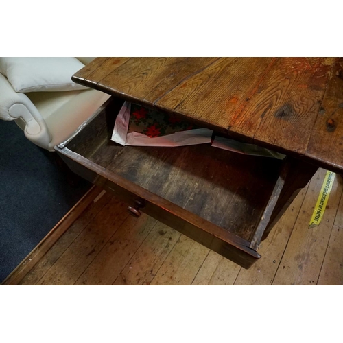 1463 - A 19th century French chestnut and oak farmhouse table, with a lateral drawer and another drawer to ... 