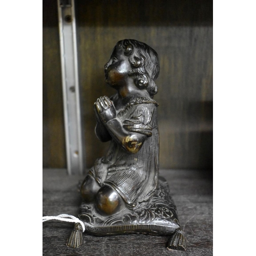 1553 - A Victorian bronze figure of a praying child, kneeling on a cushion, 15cm high.... 