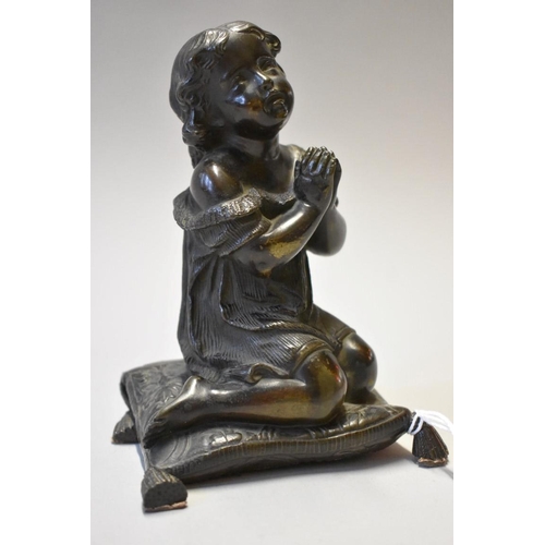 1553 - A Victorian bronze figure of a praying child, kneeling on a cushion, 15cm high.... 