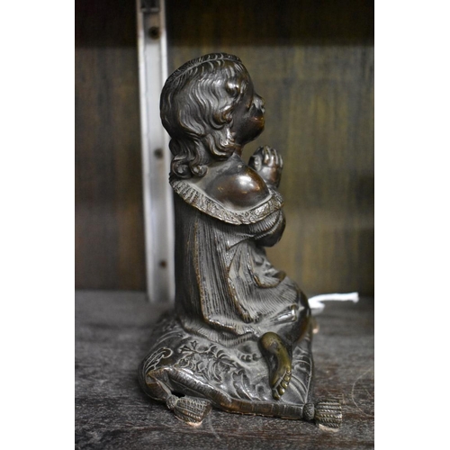 1553 - A Victorian bronze figure of a praying child, kneeling on a cushion, 15cm high.... 