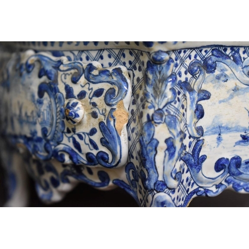 1554 - A Delft miniature commode, 18cm wide; together with another similar cow, 20cm long, (both s.d.).... 