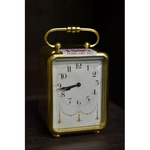 1555 - A small brass carriage timepiece, with bell striking alarm, 9.5cm high.