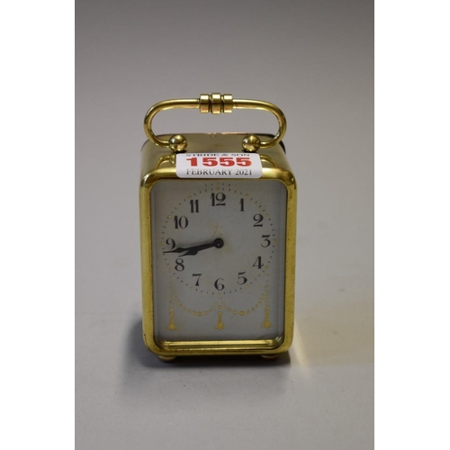 1555 - A small brass carriage timepiece, with bell striking alarm, 9.5cm high.