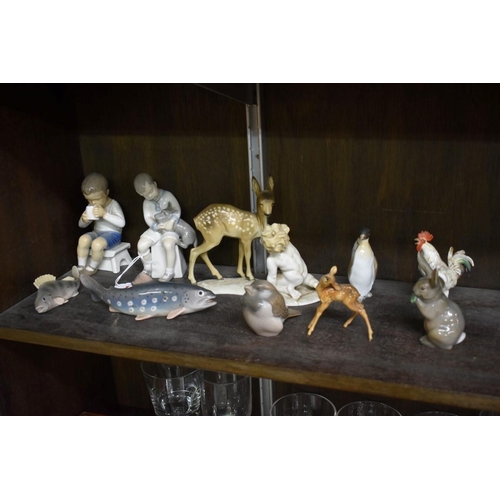 1556 - A small group of Continental porcelain figures, to include: two Bing & Grondahl boys, 13cm high;... 