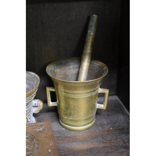 1557 - A brass or bronze twin handled mortar, 7.5cm high; together with two further mortars and pestles; an... 