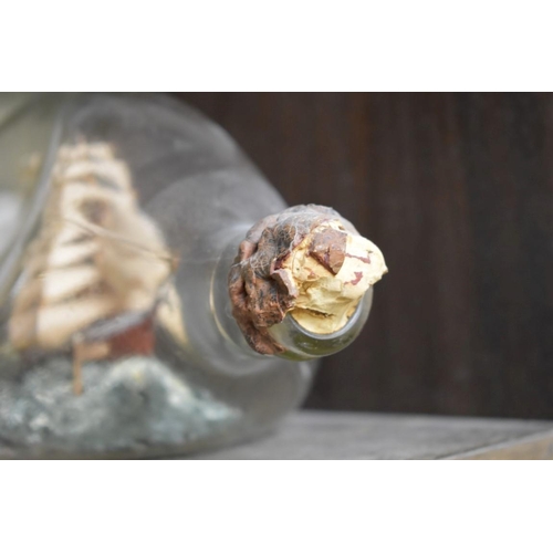 1562 - A novelty ship in Haig's Dimple whisky bottle, length excluding cork 20cm.