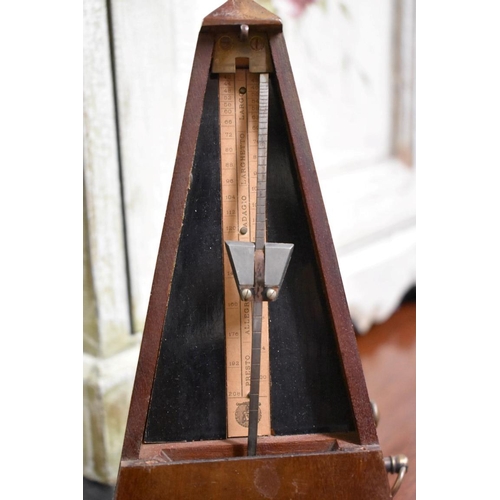 1569 - A Maelzel walnut cased metronome, No. 687450, 22cm high.