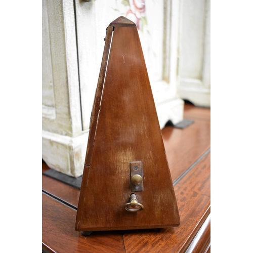 1569 - A Maelzel walnut cased metronome, No. 687450, 22cm high.