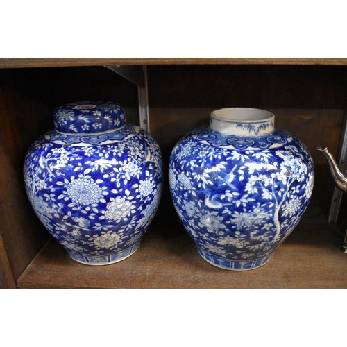 1592 - A pair of Chinese blue and white ovoid jars and one cover, 24cm high. 