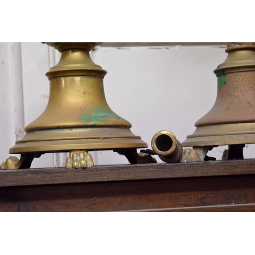 1598 - A graduated pair of brass ecclesiastical candlesticks, largest 62cm high.