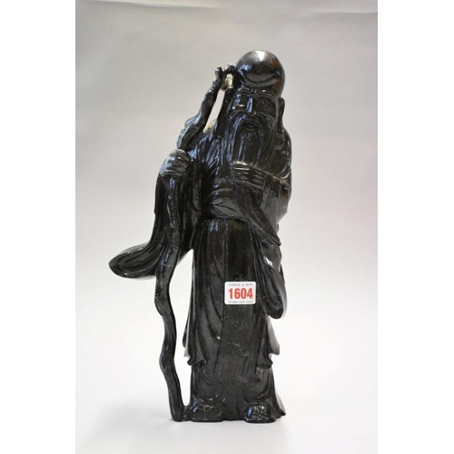 1604 - A Chinese hardstone figure of an immortal, 36.5cm high. 