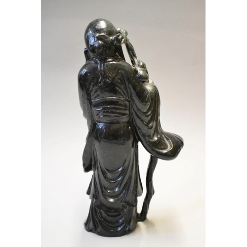 1604 - A Chinese hardstone figure of an immortal, 36.5cm high. 