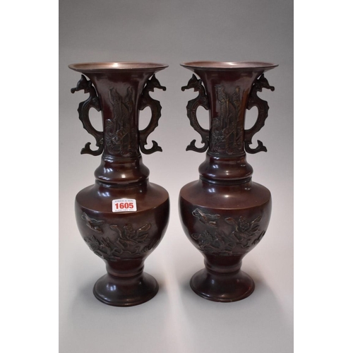 1605 - A pair of Japanese bronzed twin handled vases, 33cm high.