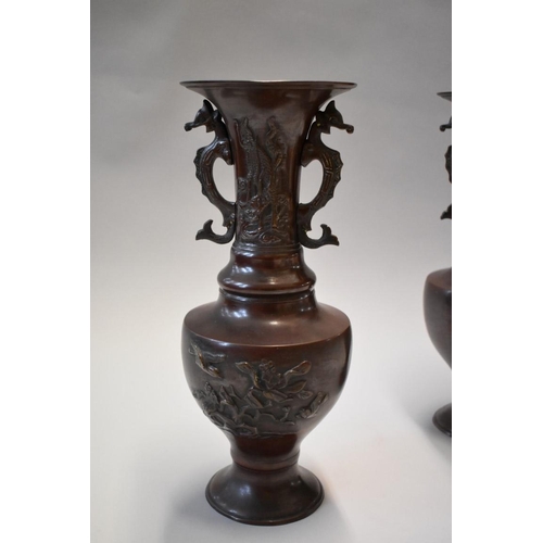 1605 - A pair of Japanese bronzed twin handled vases, 33cm high.