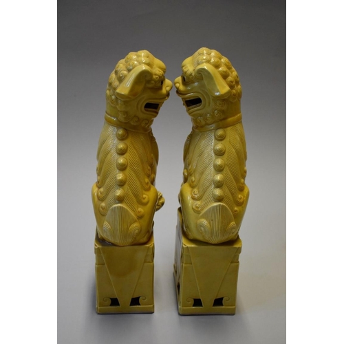 1606 - A pair of Chinese yellow glazed dogs of fo, 30cm high.