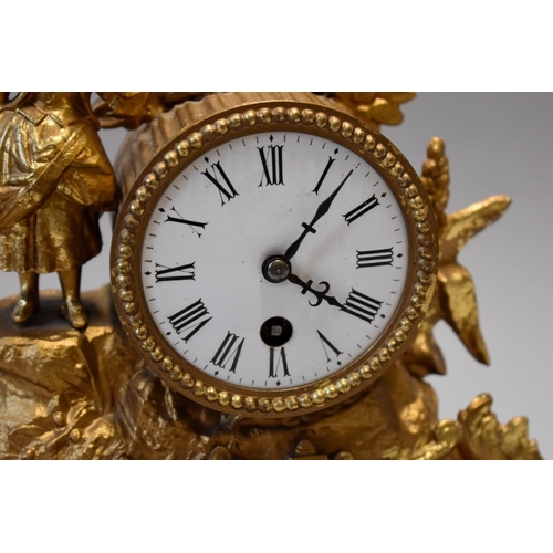 1614 - A late 19th century Continental gilt spelter mantel time piece, 26.5cm high, on wood stand, with ass... 