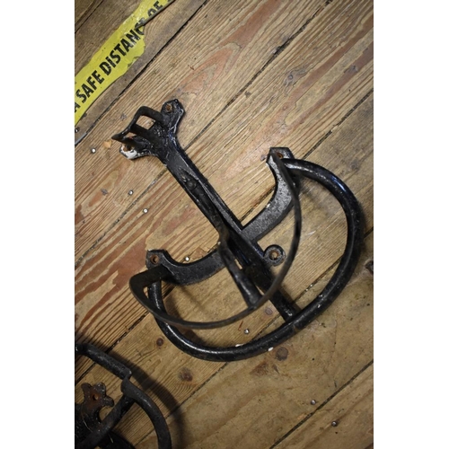 1631 - Three Victorian cast iron folding saddle hooks, each inscribed 'Cottan's Patent No.2'; together with... 