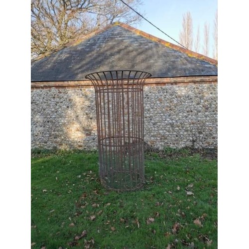 1538 - A large wrought iron tree guard, 217.5cm high x 128cm diameter.